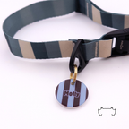 Runde personalisierte Acryl-Hundemarke mit hellblauem, dunkelblauem und bordeauxfarbenem Streifenmuster, befestigt an einem dunkelgrün-beige gestreiften Hundehalsband.